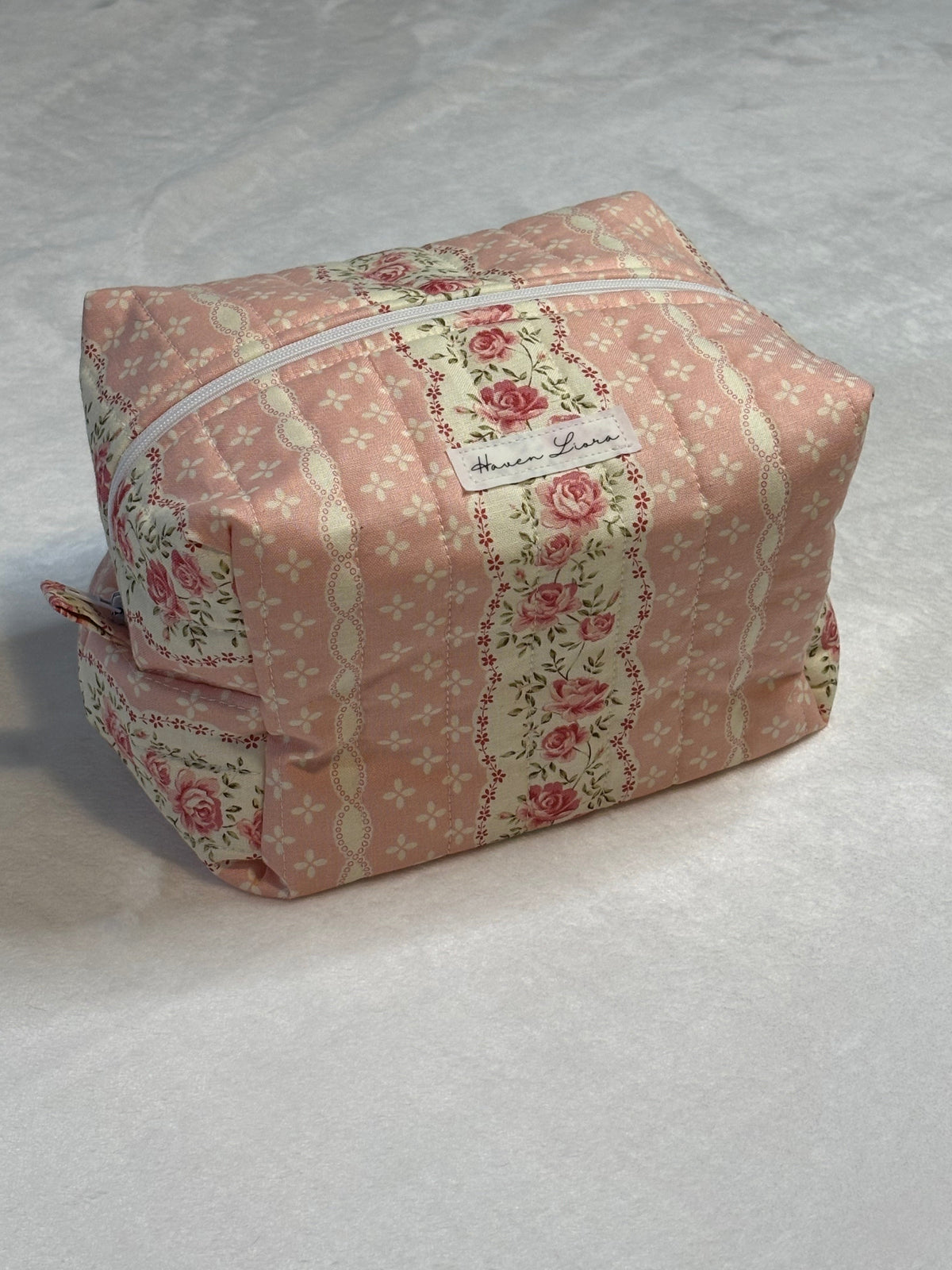 Rosebud Cottage Large Makeup Bag - front view showing blush floral and rose stripe panels