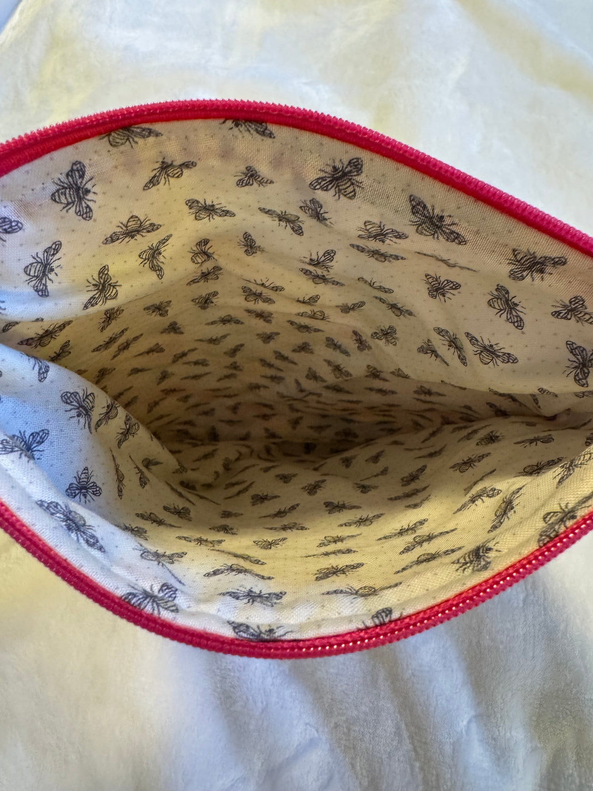 In the Garden Paperback Sleeve interior showing charming bee print lining and pink zipper