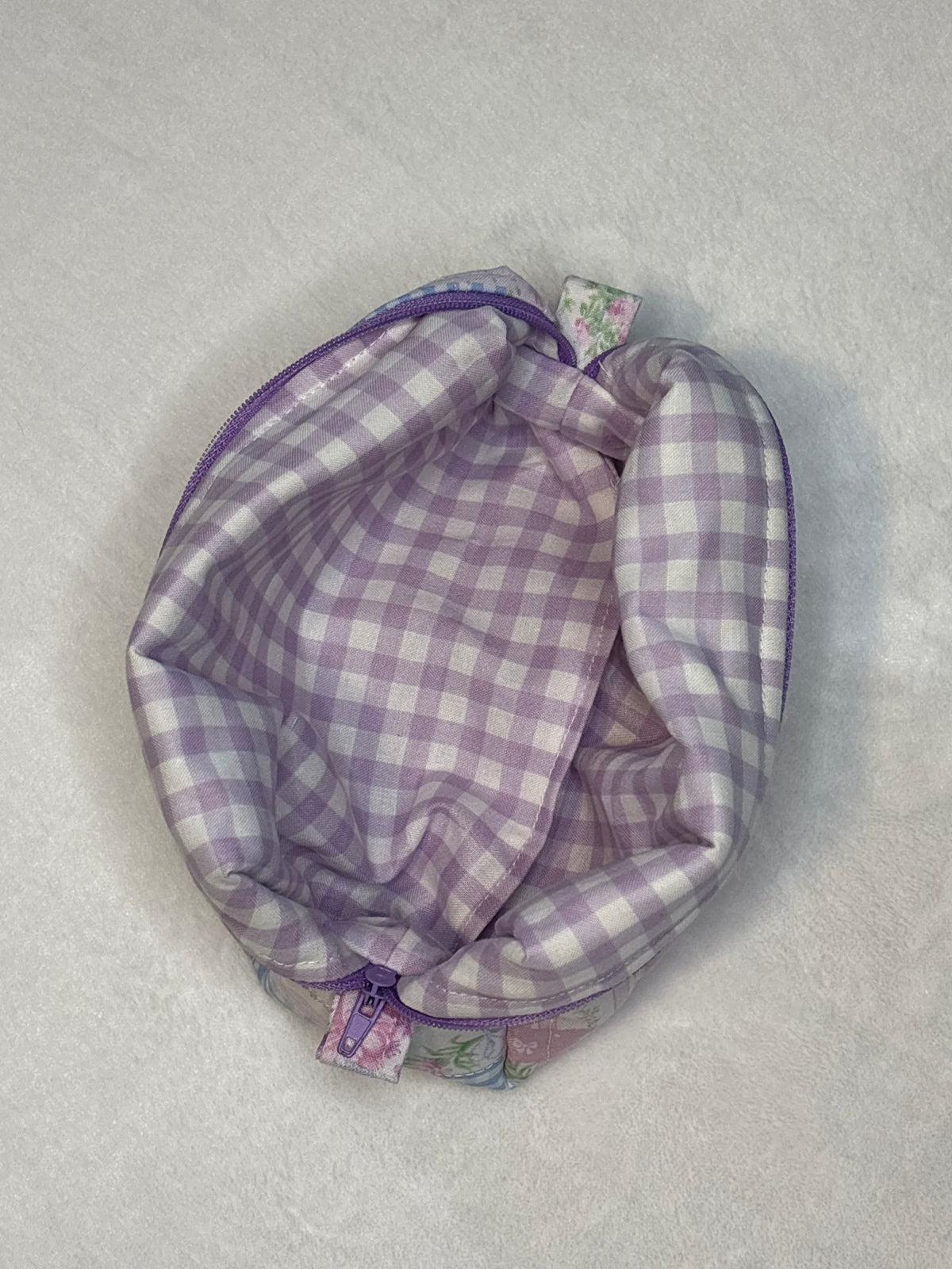 Interior of Lilac and Lace makeup bag showing lilac gingham lining