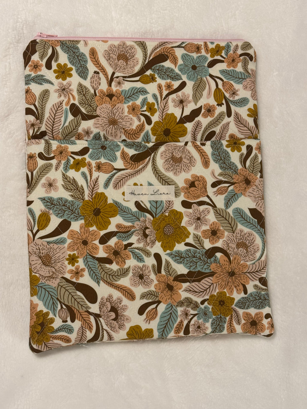 Folk Floral Tablet Sleeve shown with large hardback book to demonstrate fit