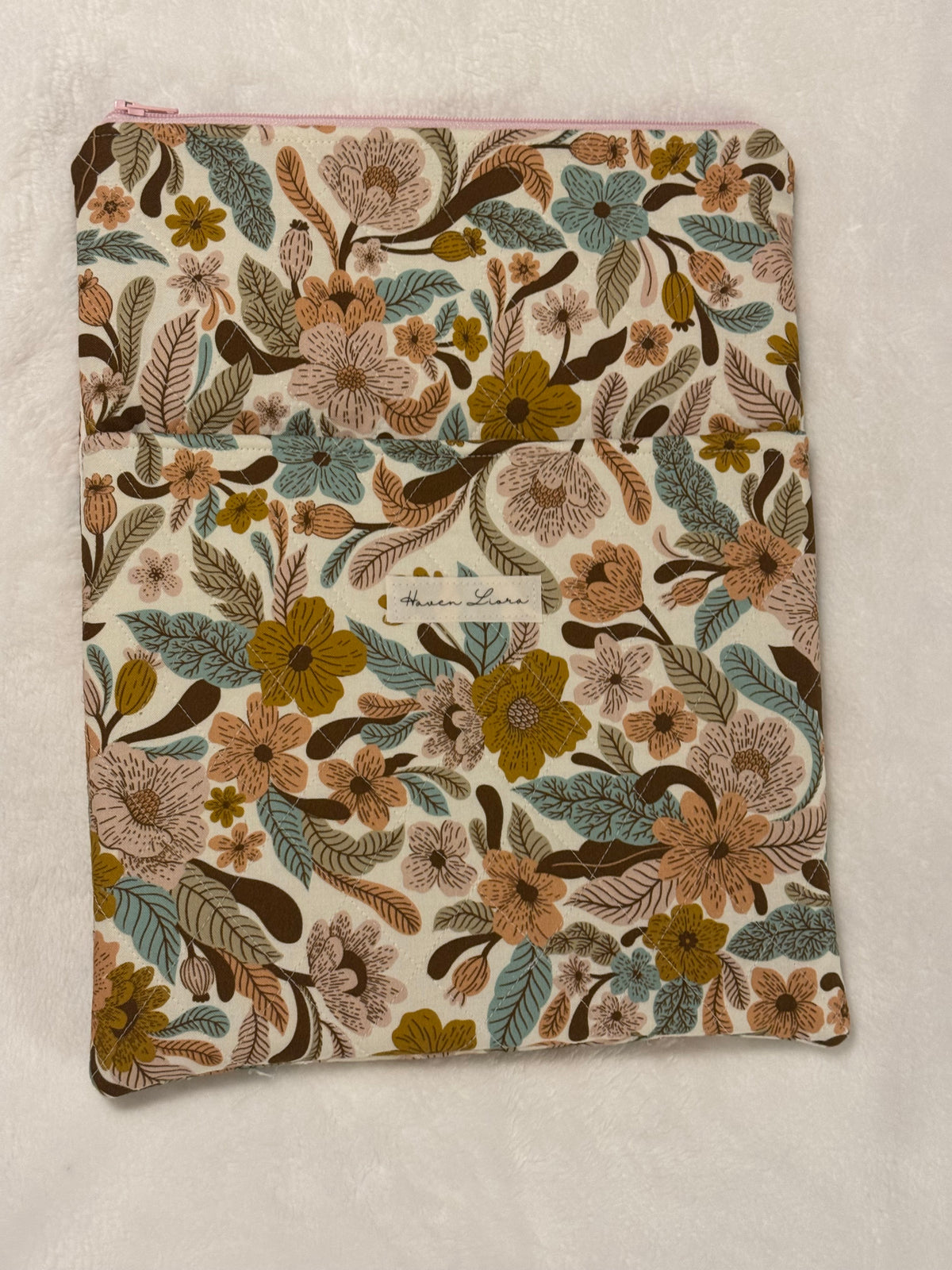 Folk Floral Tablet Sleeve shown with large hardback book to demonstrate fit