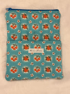 Sweet Cherry Pie Blue Kindle Sleeve exterior in sky blue strawberry and cherry print with front pocket and size comparison