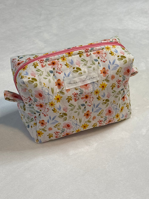 Small quilted makeup bag in Blossom and Bow floral fabric with Haven Liora label