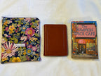 Midnight Garden Kindle Sleeve shown next to a small Bible and paperback book for size comparison