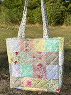 Cottage Patchwork Tote front view showing full pastel patchwork exterior with Haven Liora label