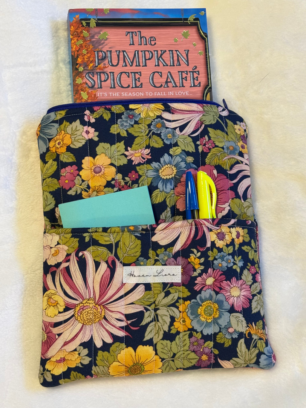 Midnight Garden Kindle Sleeve exterior in rich navy floral print with front pocket holding sticky notes and pens
