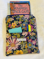 Midnight Garden Kindle Sleeve exterior in rich navy floral print with front pocket holding sticky notes and pens